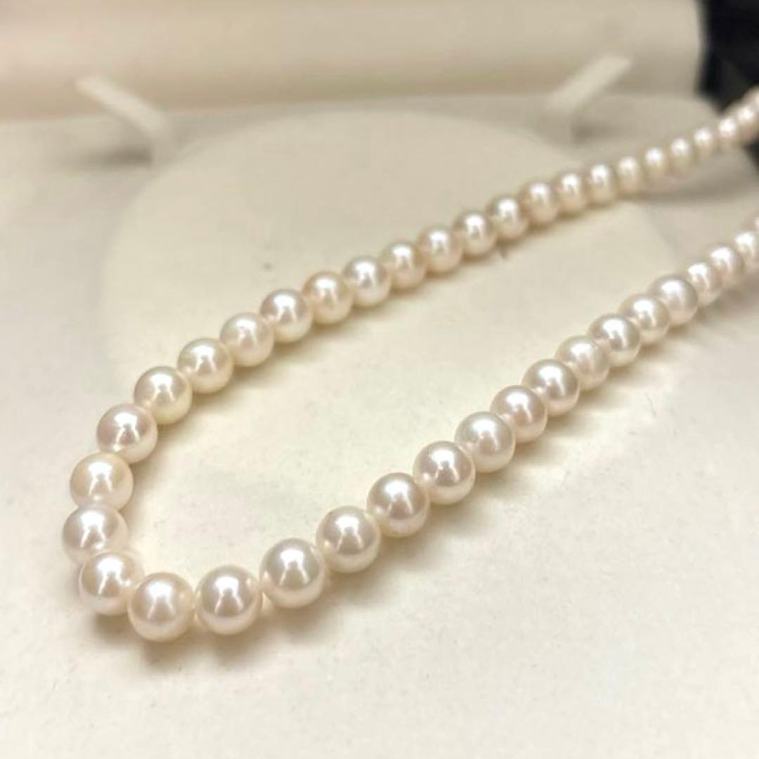 Newly polished white Akoya pearl necklace with 7mm pearls, 42cm length, laid flat