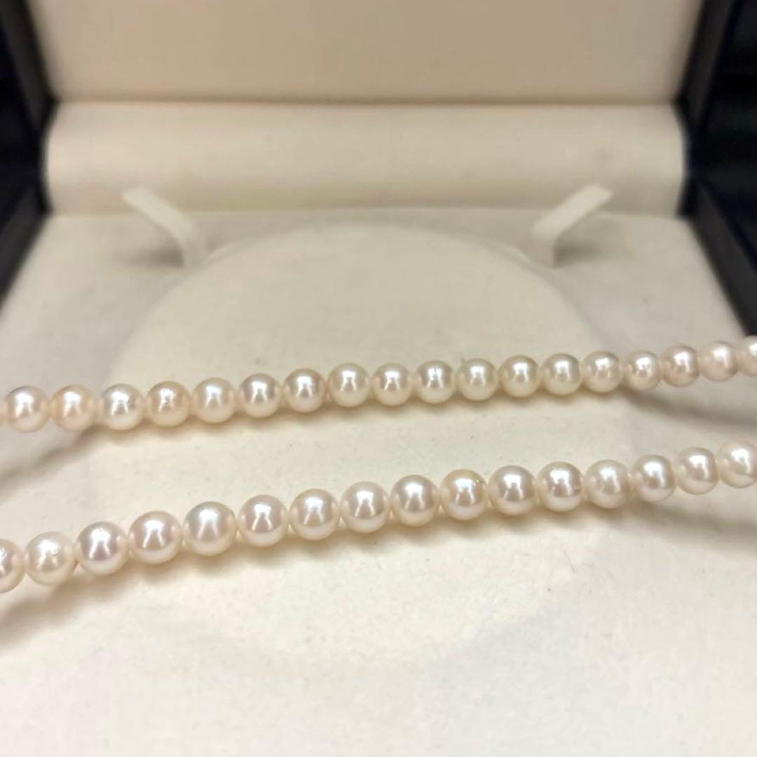 Newly polished white Akoya pearl necklace with 7mm pearls, 42cm length, laid flat
