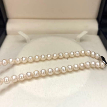 Newly polished white Akoya pearl necklace with 7mm pearls, 42cm length, laid flat