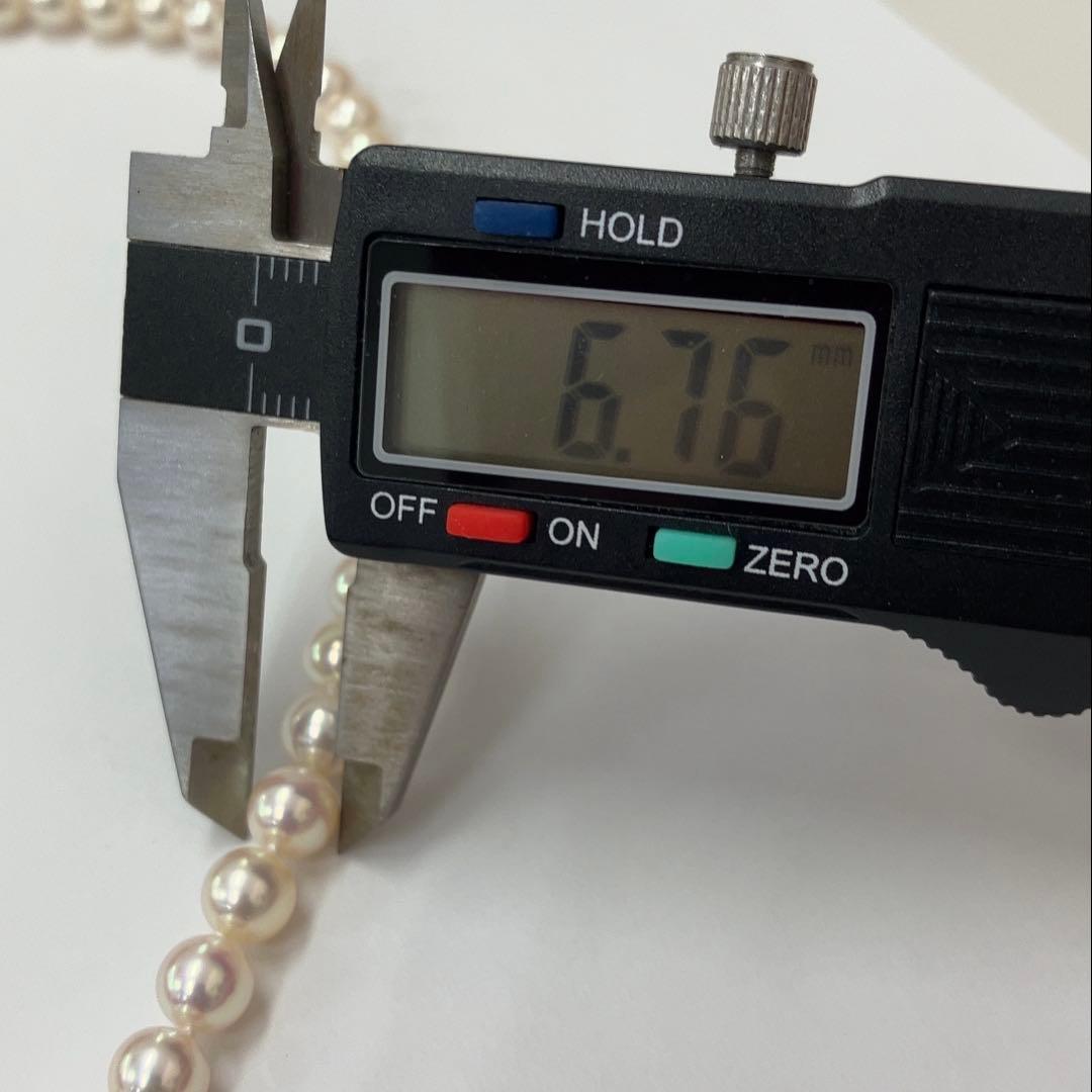 Akoya pearl necklace with approximately 6.7mm pearls and 43cm length on a white background