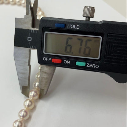 Akoya pearl necklace with approximately 6.7mm pearls and 43cm length on a white background