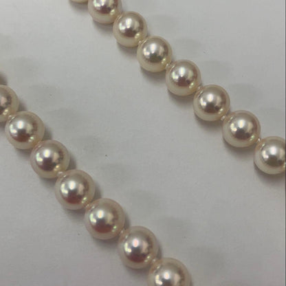 Akoya pearl necklace with approximately 6.7mm pearls and 43cm length on a white background