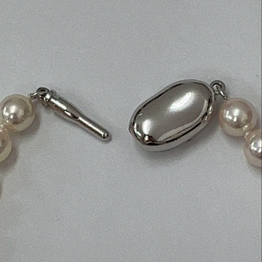 Akoya pearl necklace with approximately 6.7mm pearls and 43cm length on a white background