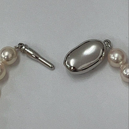 Akoya pearl necklace with approximately 6.7mm pearls and 43cm length on a white background
