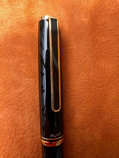 Pilot fountain pen with black body and gold accents featuring an elegant design