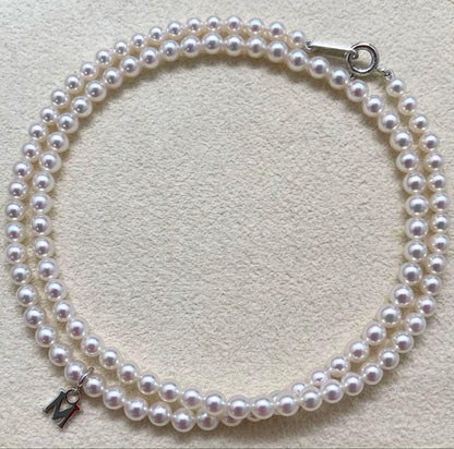Mikimoto baby pearl necklace with 3.5-4mm pearls, silver lever clasp, and M charm on a 42cm chain