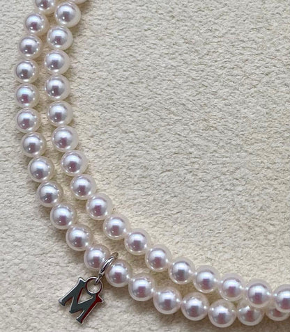 Mikimoto baby pearl necklace with 3.5-4mm pearls, silver lever clasp, and M charm on a 42cm chain