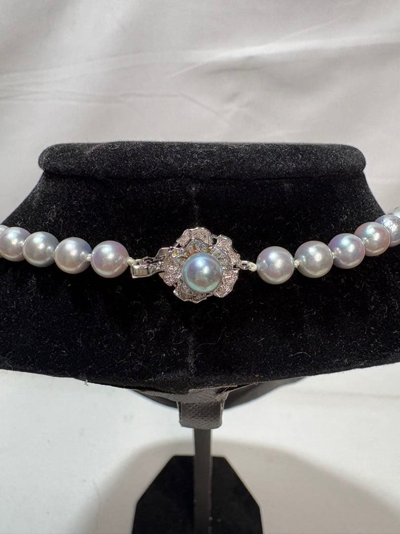 Akoya gray pearl necklace with silver chain on a white background