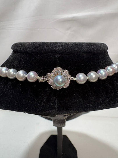 Akoya gray pearl necklace with silver chain on a white background