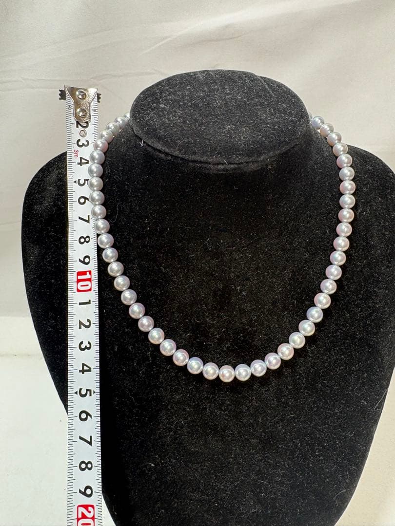 Akoya gray pearl necklace with silver chain on a white background