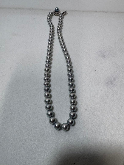 Akoya gray pearl necklace with silver chain on a white background