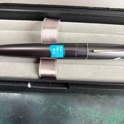PILOT Cocoon oil-based ballpoint pen in gray with logo displayed with case