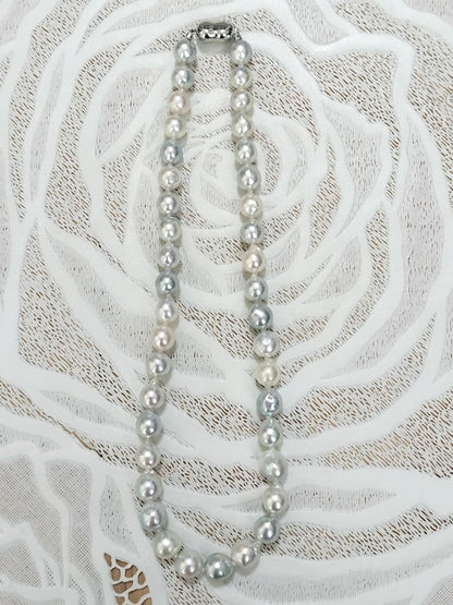 Akoya pearl large round necklace with multi-color pearls and silver push clasp on white background