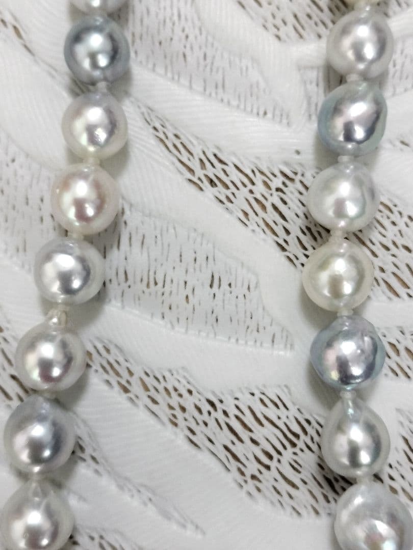 Akoya pearl large round necklace with multi-color pearls and silver push clasp on white background