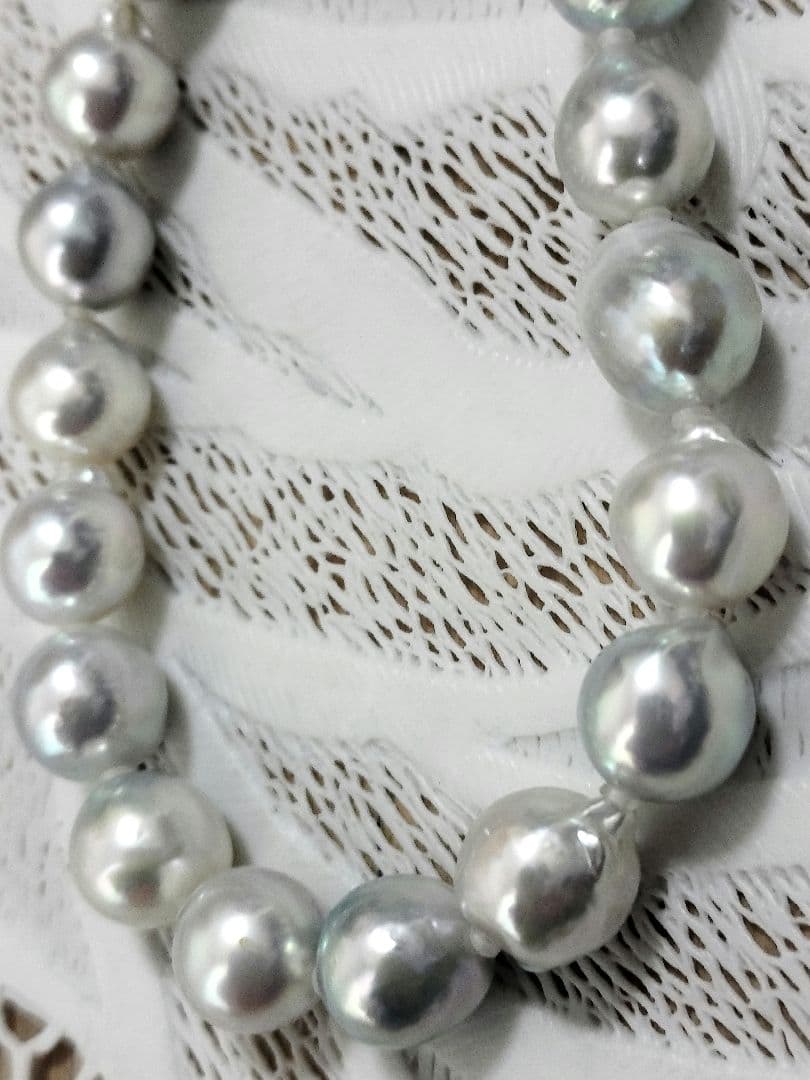 Akoya pearl large round necklace with multi-color pearls and silver push clasp on white background
