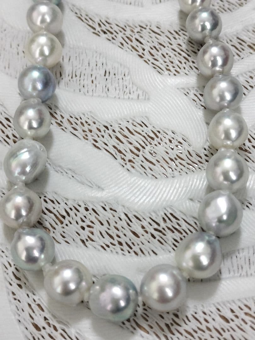 Akoya pearl large round necklace with multi-color pearls and silver push clasp on white background