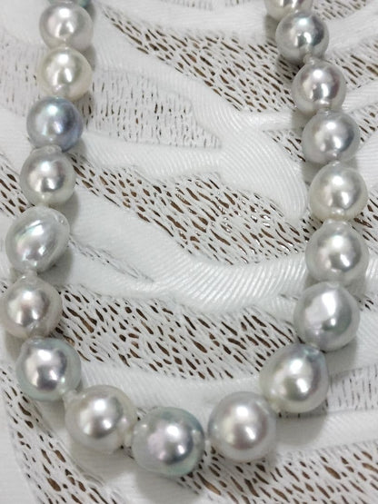 Akoya pearl large round necklace with multi-color pearls and silver push clasp on white background