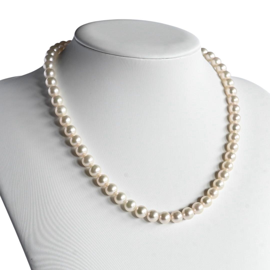 Takase Akoya pearl necklace with 7.5mm round pearls and silver ribbon clasp on a white background