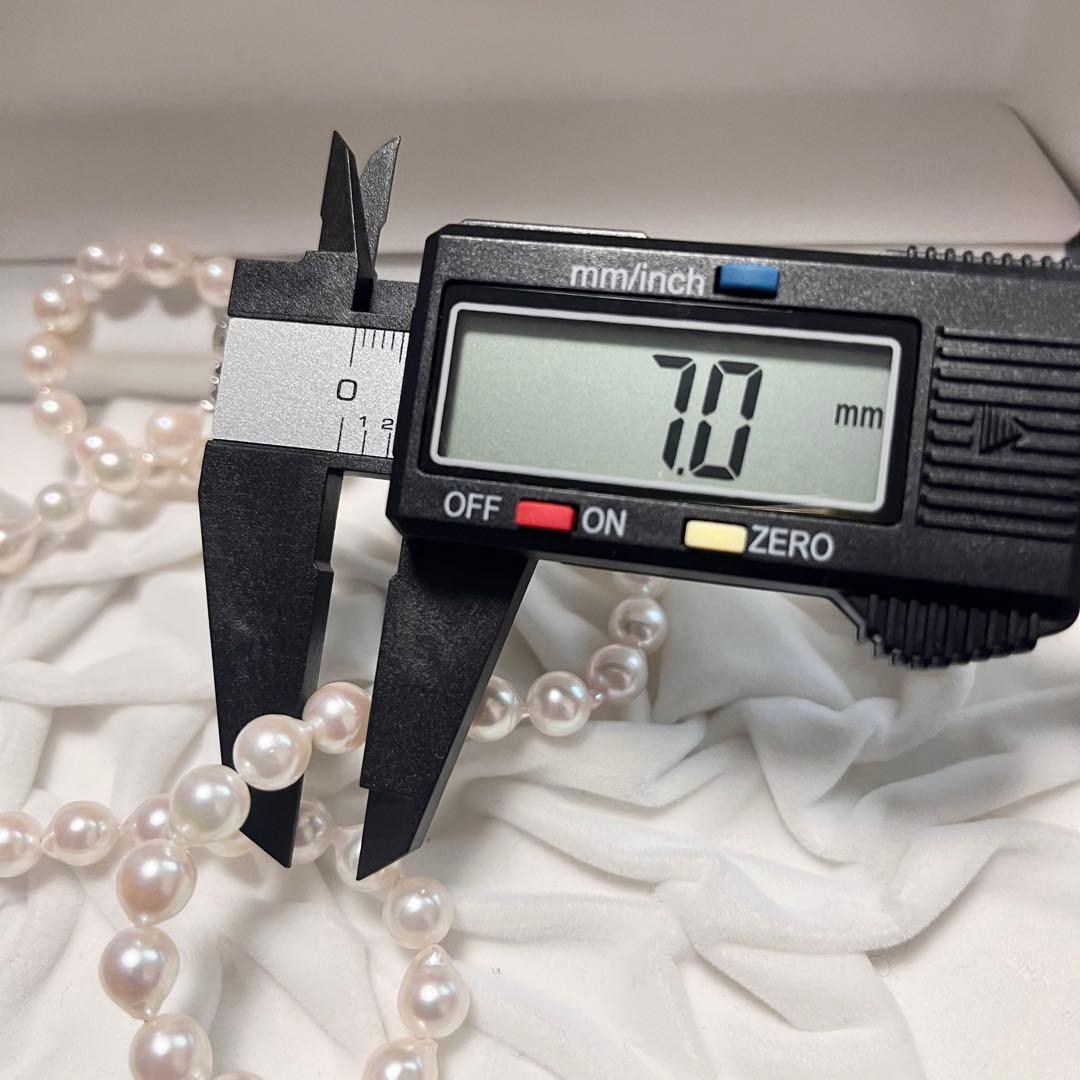 Akoya pearl necklace and matching earrings with pearls sized 6.5-7.0mm and 6.1mm on white background