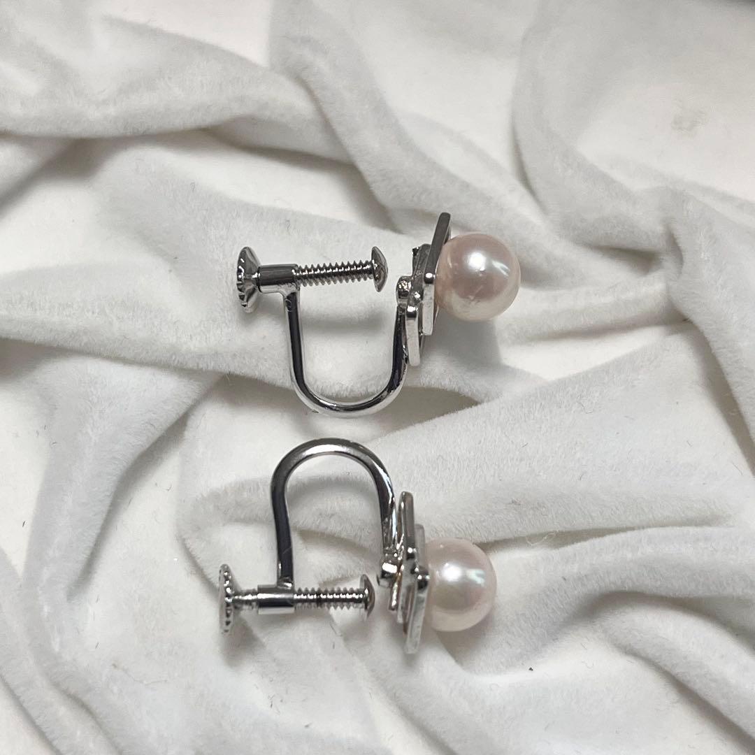 Akoya pearl necklace and matching earrings with pearls sized 6.5-7.0mm and 6.1mm on white background