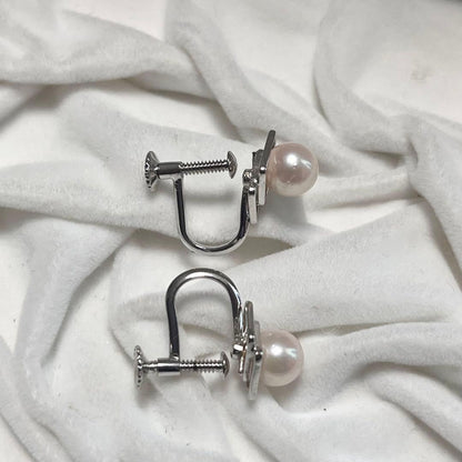 Akoya pearl necklace and matching earrings with pearls sized 6.5-7.0mm and 6.1mm on white background