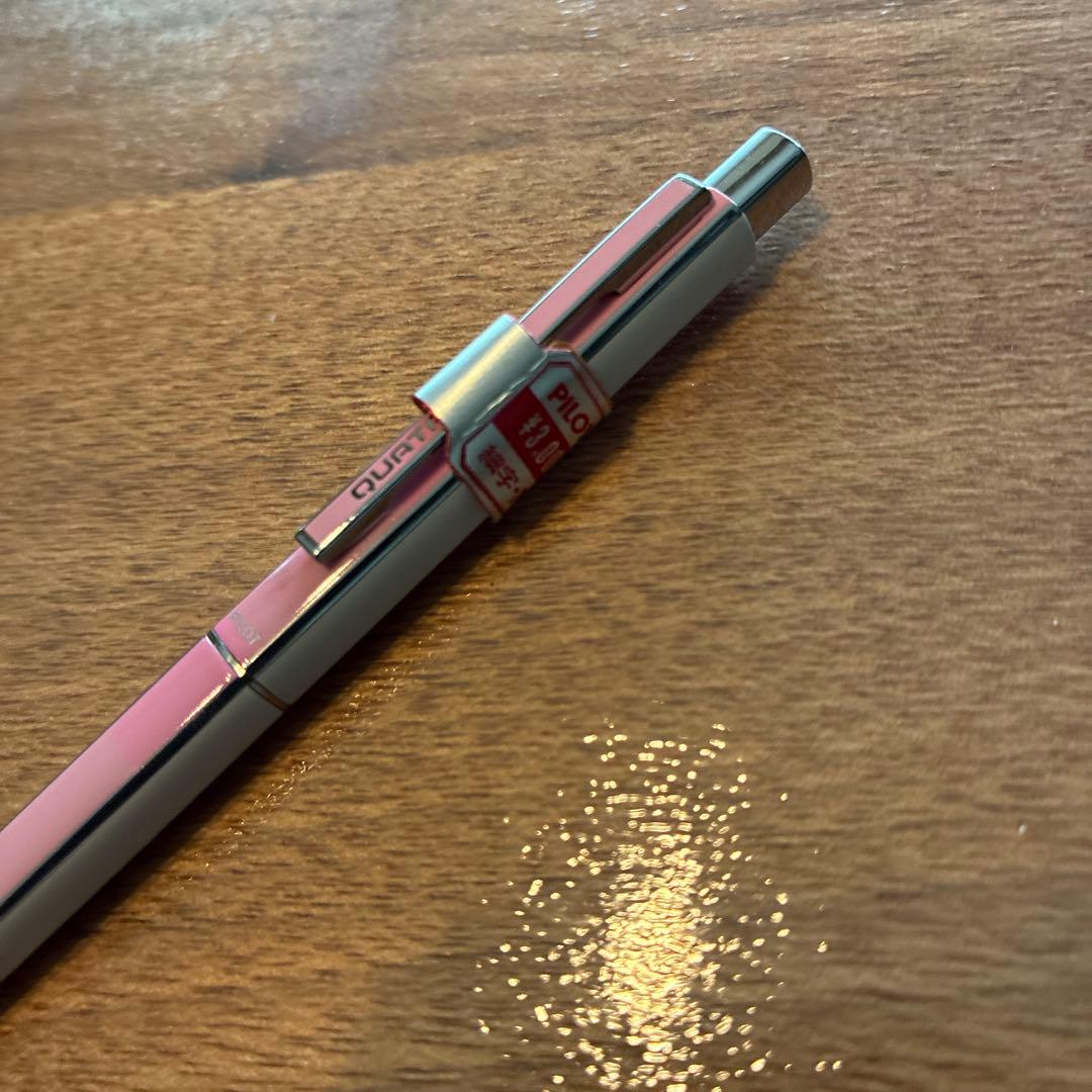PILOTQUATRO fine black ballpoint pen in pink and white with silver striped design