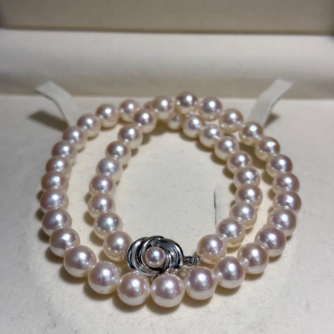 Tasaki Akoya pearl necklace with 9.0 mm pink pearls and silver closure on a white background