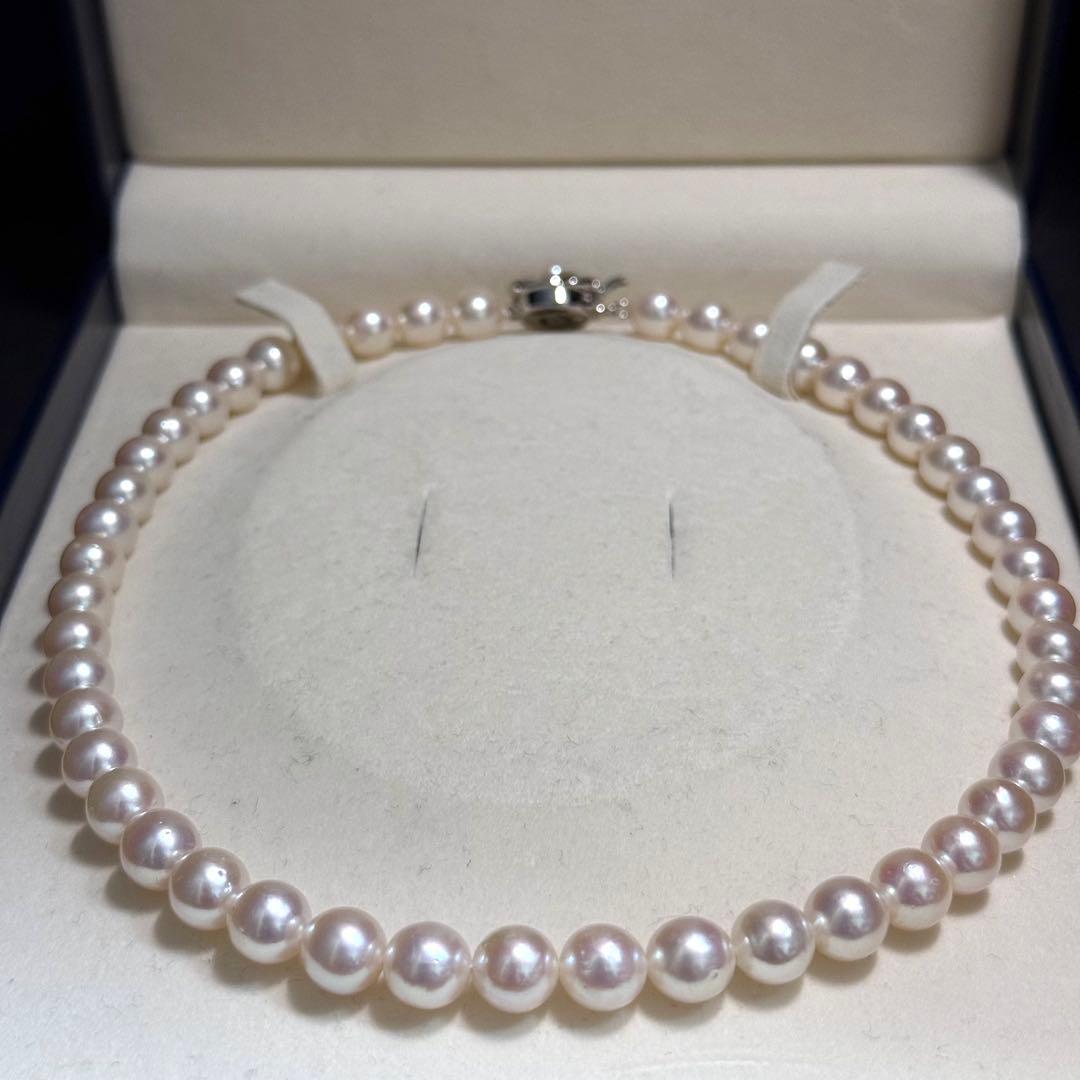 Tasaki Akoya pearl necklace with 9.0 mm pink pearls and silver closure on a white background