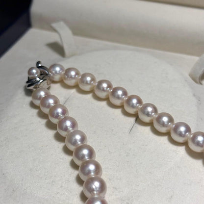 Tasaki Akoya pearl necklace with 9.0 mm pink pearls and silver closure on a white background