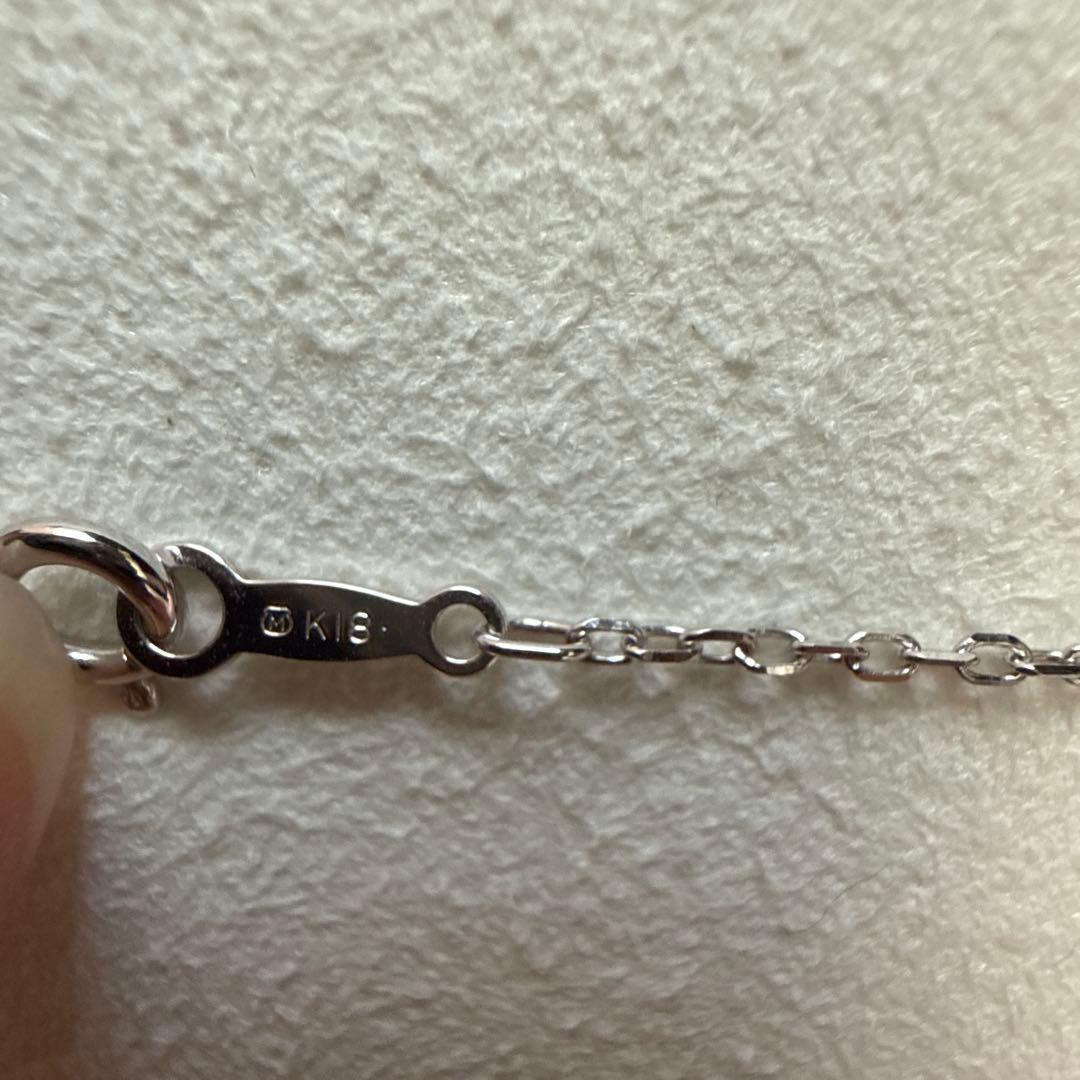 Mikimoto pearl necklace made of 18K white gold displayed on a white background