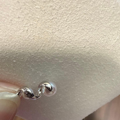 Mikimoto pearl necklace made of 18K white gold displayed on a white background