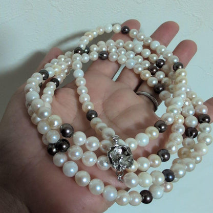 Akoya pearl long necklace with white and cream pearls sized 5.5 to 7 mm showing natural dents and wrinkles