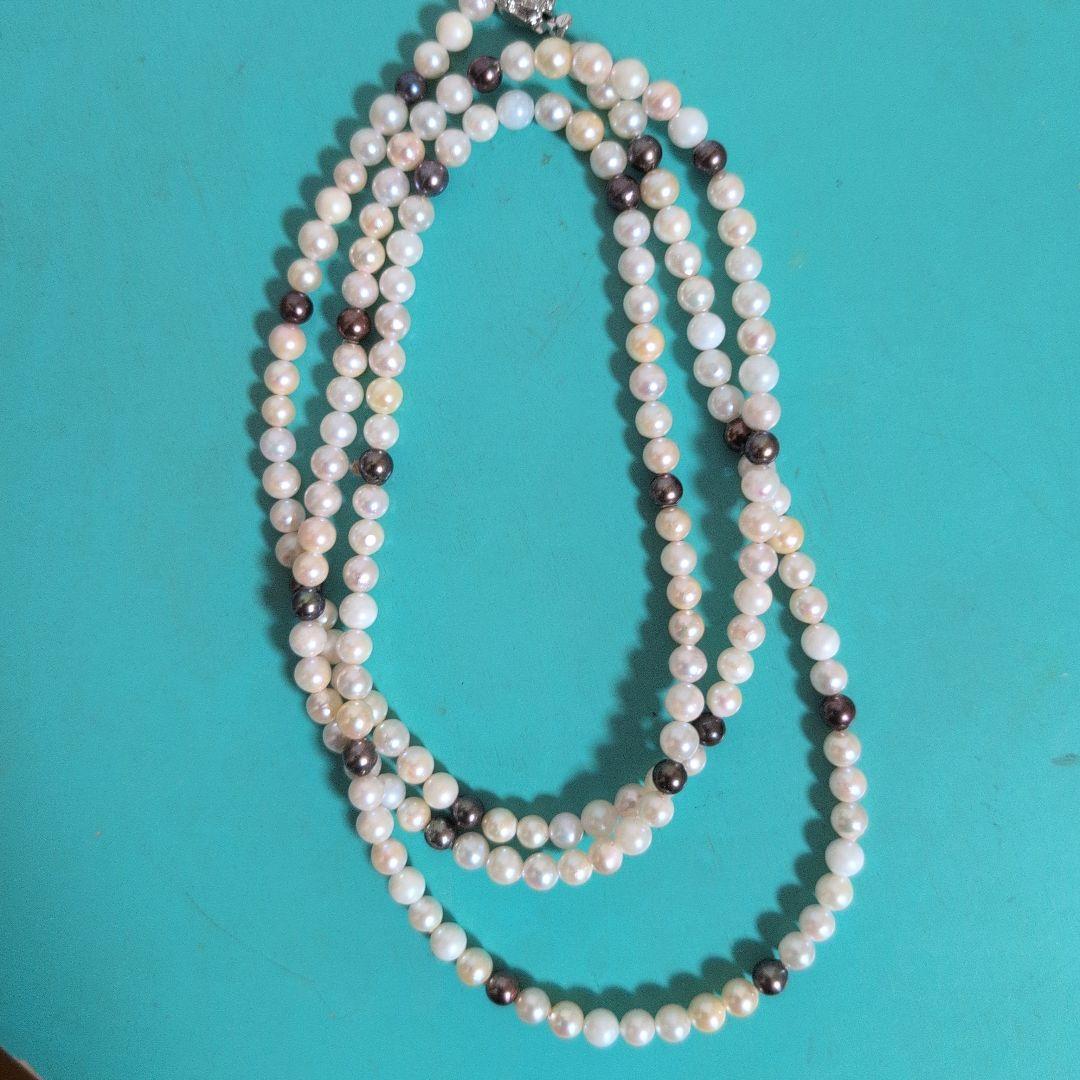 Akoya pearl long necklace with white and cream pearls sized 5.5 to 7 mm showing natural dents and wrinkles