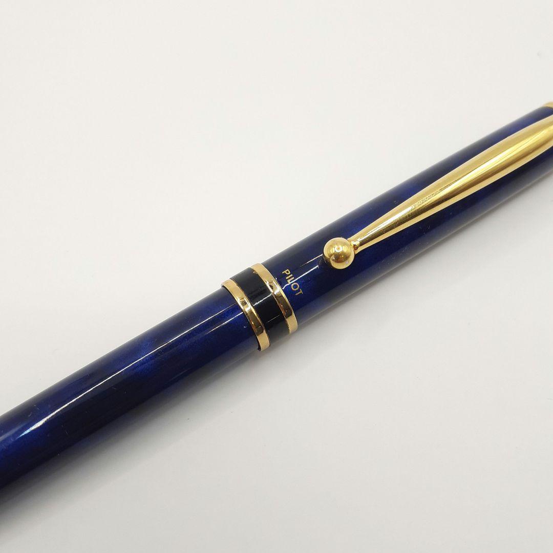 Used Pilot ballpoint pen in blue marble pattern with visible small scratches and paint chips