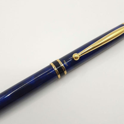 Used Pilot ballpoint pen in blue marble pattern with visible small scratches and paint chips