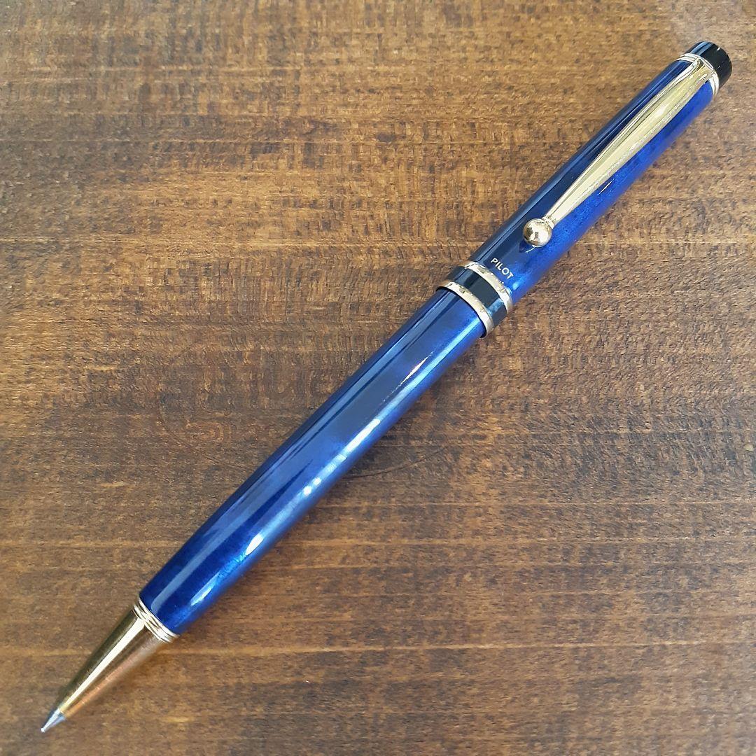 Used Pilot ballpoint pen in blue marble pattern with visible small scratches and paint chips