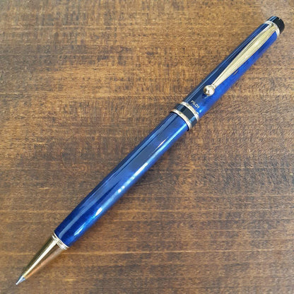 Used Pilot ballpoint pen in blue marble pattern with visible small scratches and paint chips