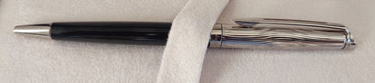 WATERMAN Paris ballpoint pen with silver wave pattern cap and black body beside a blue gift box