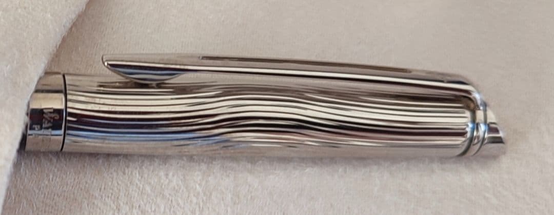 WATERMAN Paris ballpoint pen with silver wave pattern cap and black body beside a blue gift box