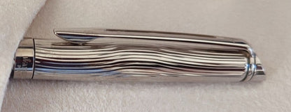 WATERMAN Paris ballpoint pen with silver wave pattern cap and black body beside a blue gift box