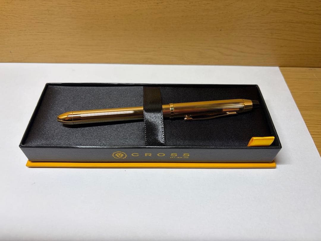 Gold CROSS multi-function ballpoint pen with dedicated case on white background