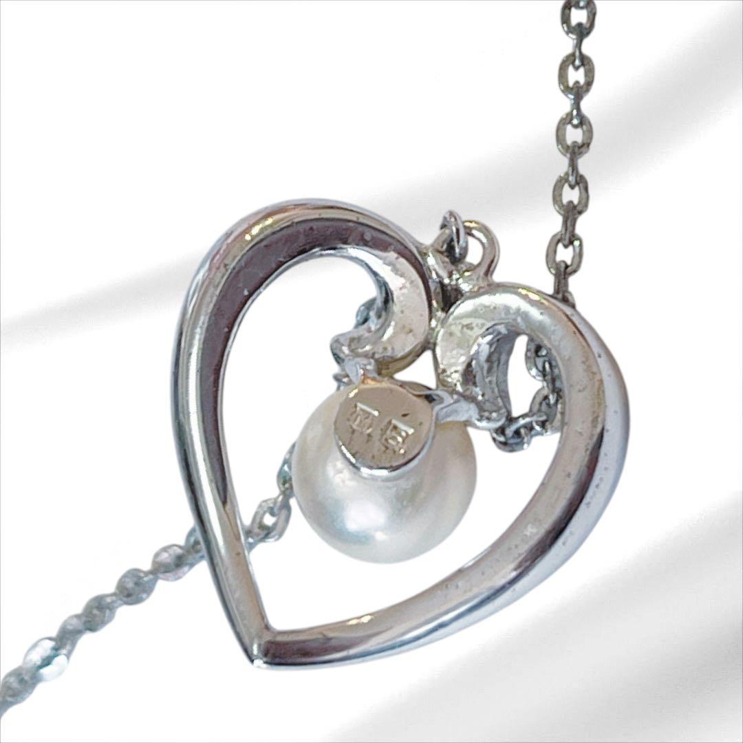 Mikimoto pearl necklace with silver heart pendant and 37 cm Akoya pearls on white background
