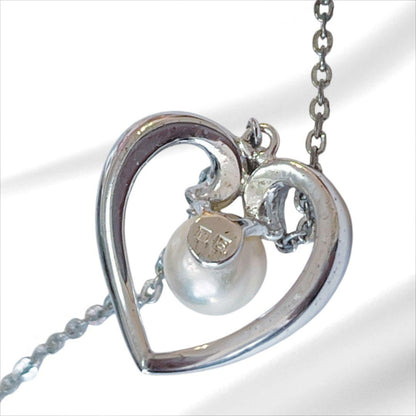 Mikimoto pearl necklace with silver heart pendant and 37 cm Akoya pearls on white background