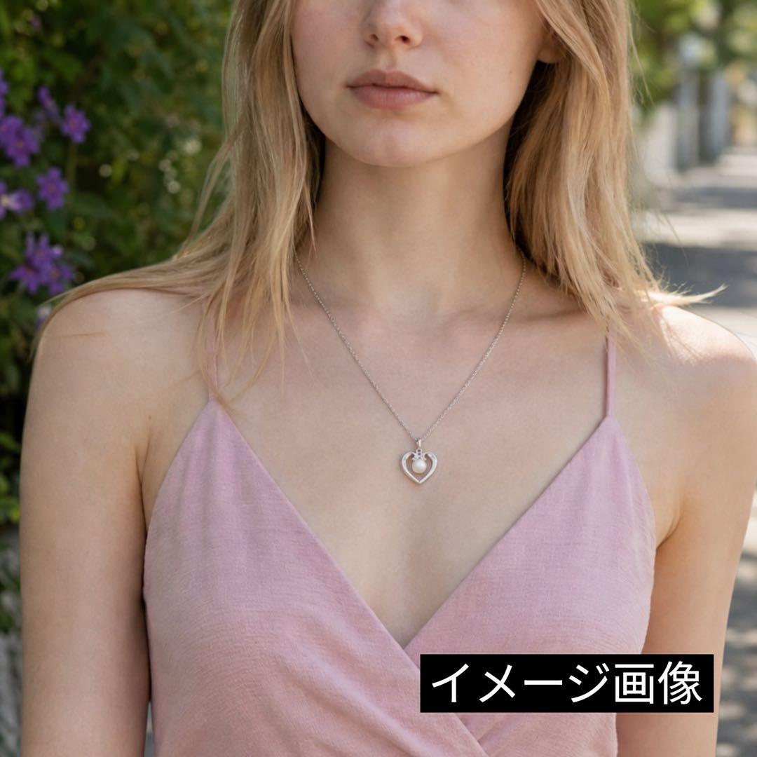Mikimoto pearl necklace with silver heart pendant and 37 cm Akoya pearls on white background
