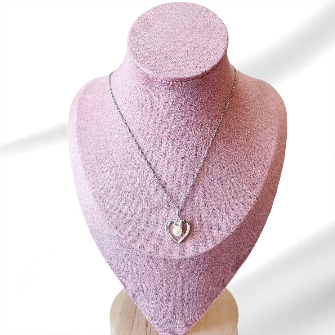 Mikimoto pearl necklace with silver heart pendant and 37 cm Akoya pearls on white background