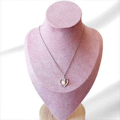 Mikimoto pearl necklace with silver heart pendant and 37 cm Akoya pearls on white background