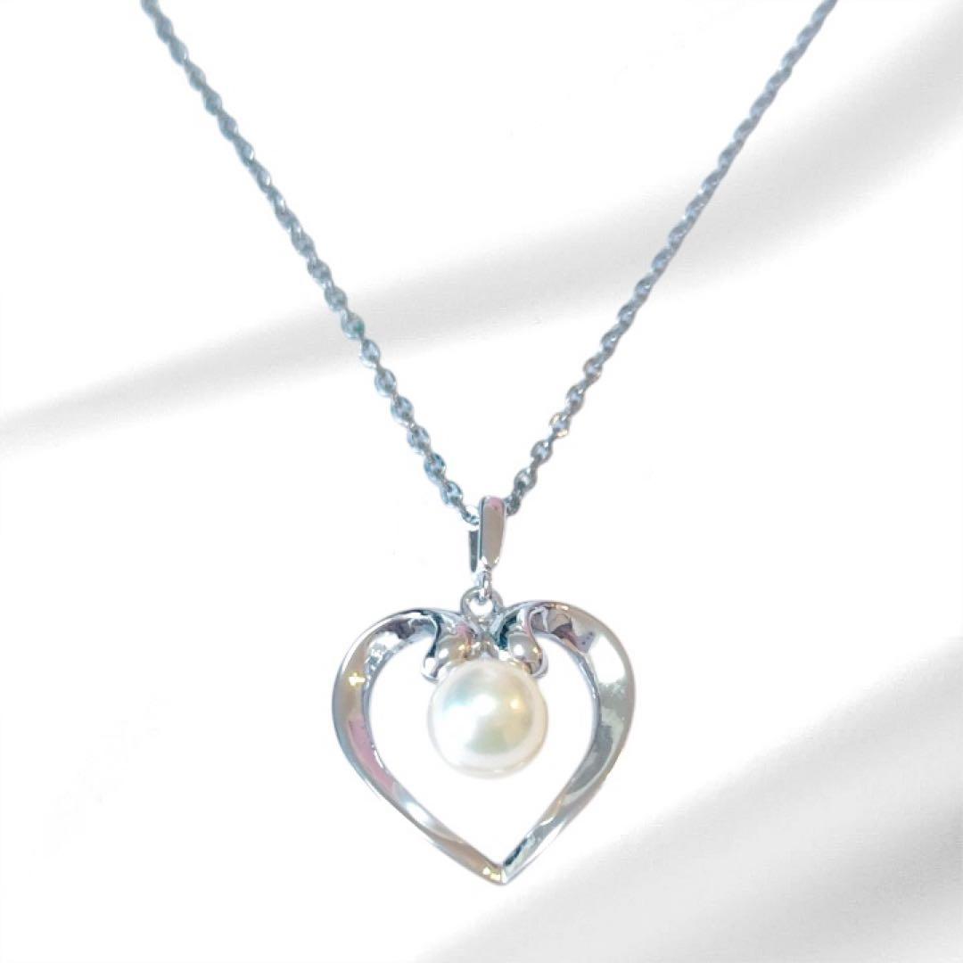 Mikimoto pearl necklace with silver heart pendant and 37 cm Akoya pearls on white background