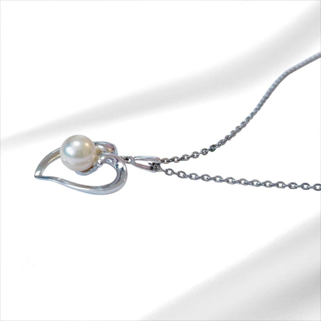 Mikimoto pearl necklace with silver heart pendant and 37 cm Akoya pearls on white background