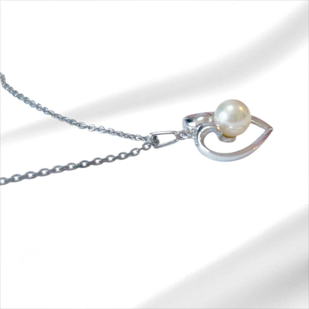 Mikimoto pearl necklace with silver heart pendant and 37 cm Akoya pearls on white background