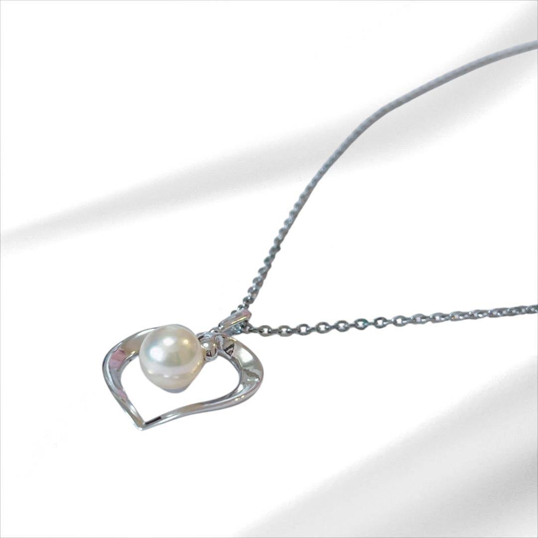 Mikimoto pearl necklace with silver heart pendant and 37 cm Akoya pearls on white background